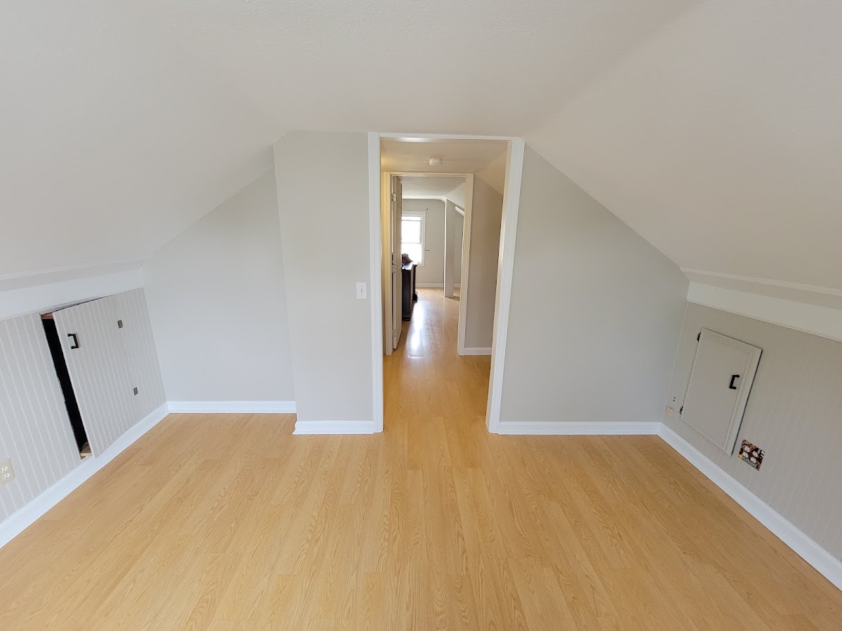 Freshly painted white attic bedroom